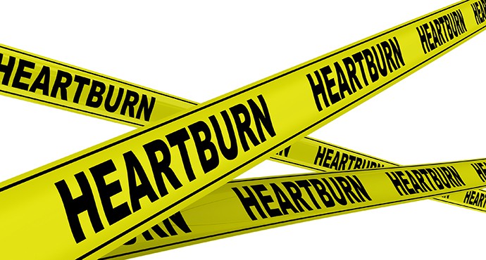 Yellow warning tapes with inscription "HEARTBURN". Isolated